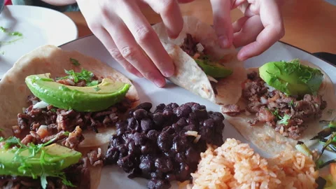 Eating soft shell sirloin beef steak taco with avocado Mexican food full plat Video stock 160606688