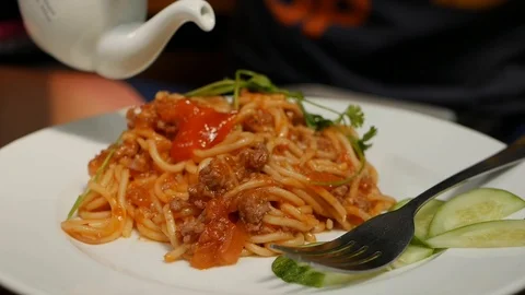 Eating spaghetti bolognese with a fork. Fork twisting in succulent hot spaghetti Video stock 116318442
