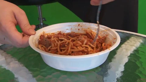 Eating spaghetti in front of a green screen Video stock 81170055