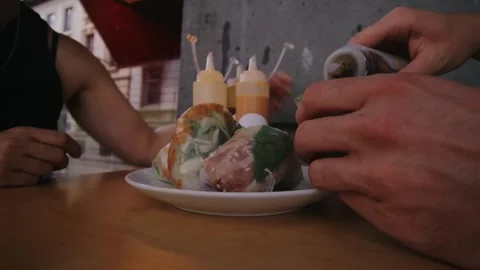 Eating springrolls and adding different sauces Stock Footage 252574556