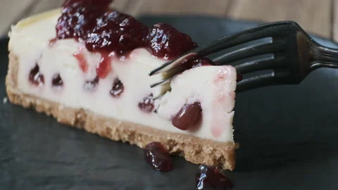 Eating strawberry cheesecake. Taking bite of healthy raspberries vegan cake Video stock 148693062