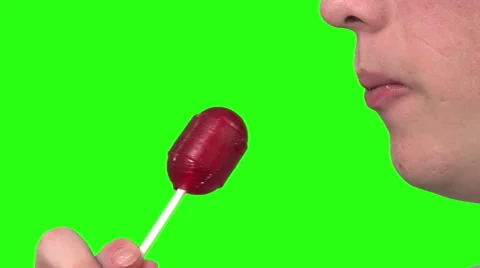 Eating a sucker, green background Video stock 49862687