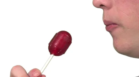 Eating a sucker, white background Stock Footage 49862697