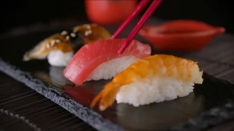 Eating sushi roll with red chopsticks Stock Footage 69720698