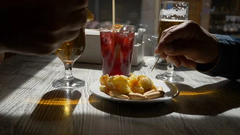 Eating Tapas on a Table bar with two beers and one tinto de Verano. Hands 스톡 동영상 128970124