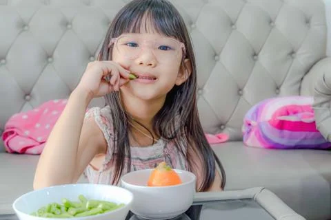 Eating vegetables by child make them healthier Stock Photos