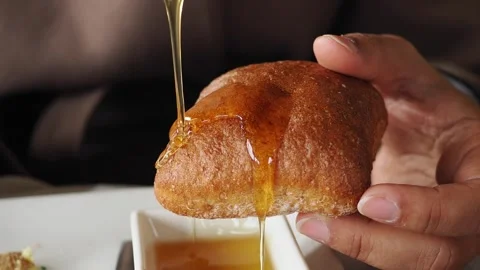 Eating warm bread with honey at a cafe in the morning Stock Footage 345389008