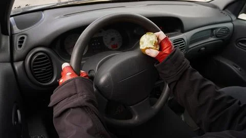 Eating while driving Stock Photos