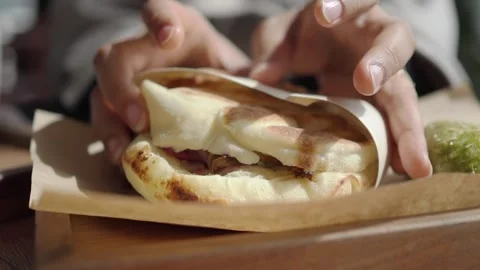 Eating wrapped bread with filling and green dessert Stock Footage 340443894