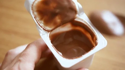 Eating yogurt from a plastic cup Video stock 81329927