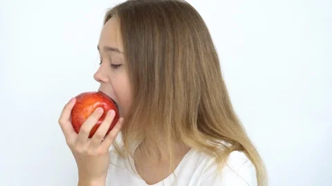 Eats a bright red apple Stock Footage 111042732