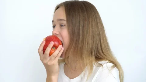 Eats a bright red apple Stock Footage 111043245
