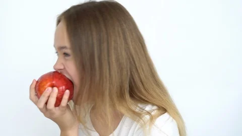 Eats a bright red apple Stock Footage 111043402