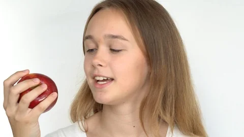 Eats a bright red apple Stock Footage 111043746