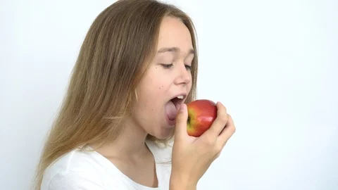 Eats a bright red apple Stock Footage 111043942