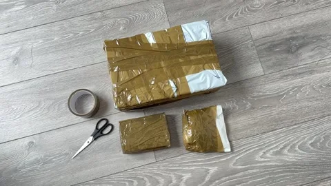 Ebay parcels wrapped Close Up of Cardboard Packages Wrapped with Duct Tape Video stock 318220312