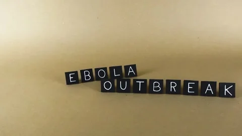 Ebola outbreak words gliding on a brown paper background Stock Footage 345161346