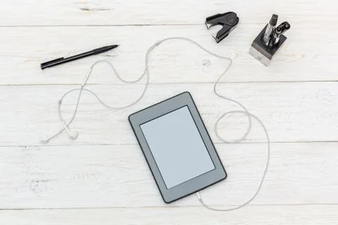 Ebook and stationery on white boards Stock Photos