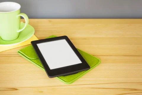 Ebook reader on a wooden table Stock Photos