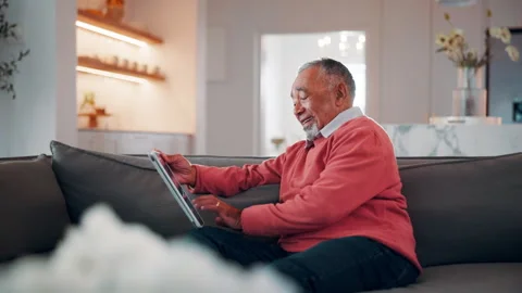 Ebook, search or old man in home with tablet, entertainment or publication Stock Footage 338396066
