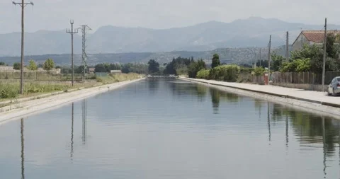 Ebro river as it passes through the towns of the Ebro Delta Stock Footage 133904746
