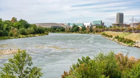 Ebro River as it passes through Zaragoza next to the modern business buildings Stock Photos