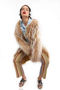Eccentric model posing in a fur coat Stock Photos
