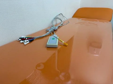 Ecg machine on orange examination table in a clean medical clinic, concept of Stock-Fotos