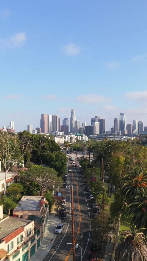 Echo Park Lake backwards movement displaying downtown Los Angeles skyline with p Stock Footage 336634501
