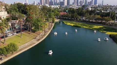 Echo Park lake featuring pedal boats navigating calm waters, downtown Los Angele Stock Footage 336634492