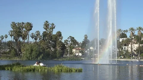 Echo Park Lake with rainbow prism in fountain and people on pedal boat Stock Footage 75880837