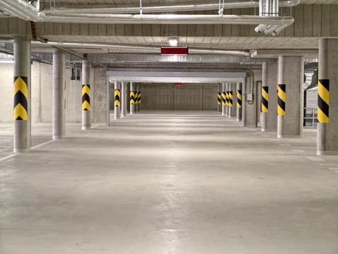 Echoing columns in long corridor, symmetrical industrial corridor with Stock Photos