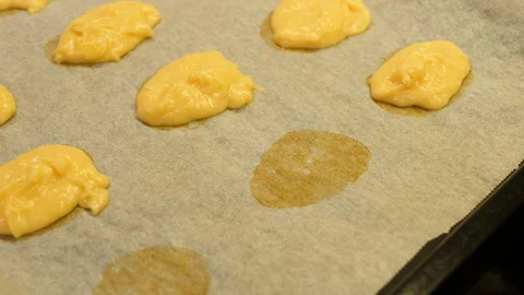 Eclair baked. Women hand adding on Tray. Made of Choux Dough filling Vanilla. Stock Footage 129260212
