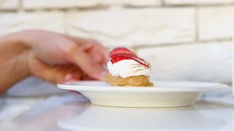 Eclair cake decorated with cream and strawberry berries 動画素材 220508361