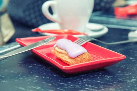 Eclair cake in a red rectangular plate Eclair cake in a red rectangular pl... Stock Photos