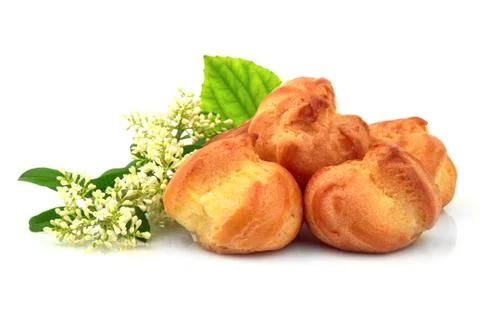Eclair, custard, cake, profiterole with fresh morning flower. Isolated on whi Stock Photos