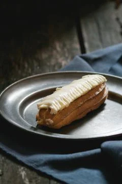 Eclair in metal plate Stock Photos