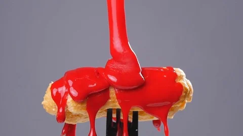 Eclair pour glaze gray background Stock Footage 69834833