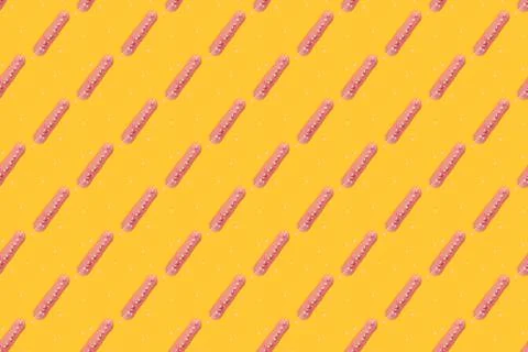 Eclair seamless pattern on a yellow background. Stock Photos