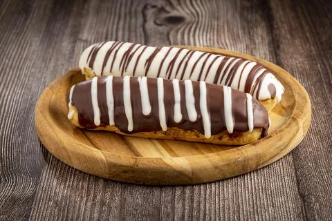 Eclair. Tasty chocolate eclair on the table. Stock Photos