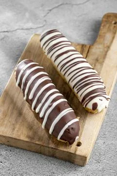 Eclair. Tasty chocolate eclair on the table. Stock Photos