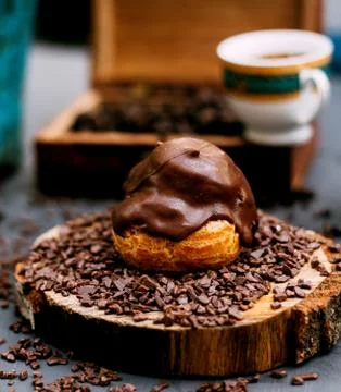 Eclair topped with melted chocolate Stock Photos