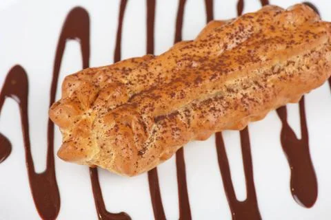 Eclair traditional eclair on a choco background. Copyright: xZoonar.com/Ru... Stock Photos