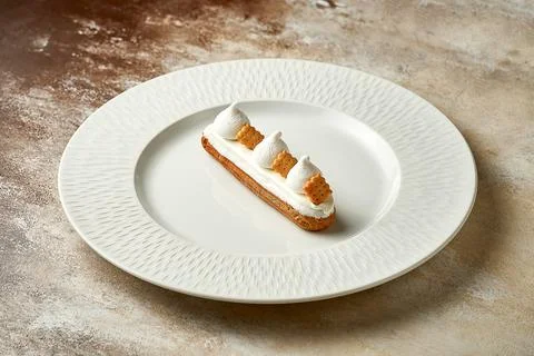 Eclair with white frosting and custard. Selective focus, close-up Stock Photos