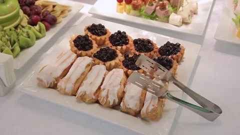 Eclairs and cake on the table Stock Footage 70686780