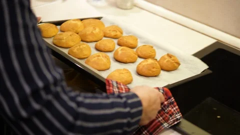 Eclairs baked in Oven on Table. Made of Choux Dough filled with Vanilla cream.  Stock-Footage 129306474