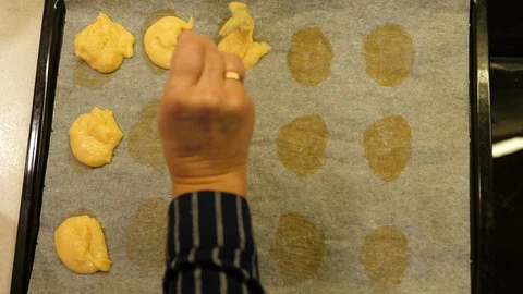 Eclairs baking. Women hand adding on Tray. Made of Choux Dough filled Vanila. Stock-Footage 129259858