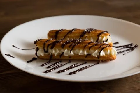 Eclairs with a delicate cream inside Stock Photos