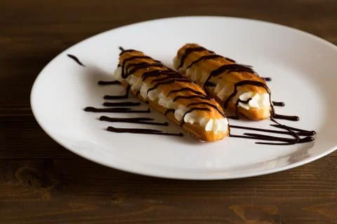 Eclairs with a delicate cream inside Stock Photos