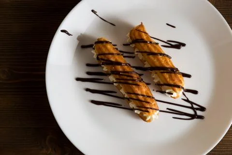 Eclairs with a delicate cream inside Stock Photos